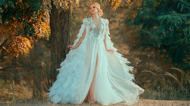 Bride wearing wedding dress with cape