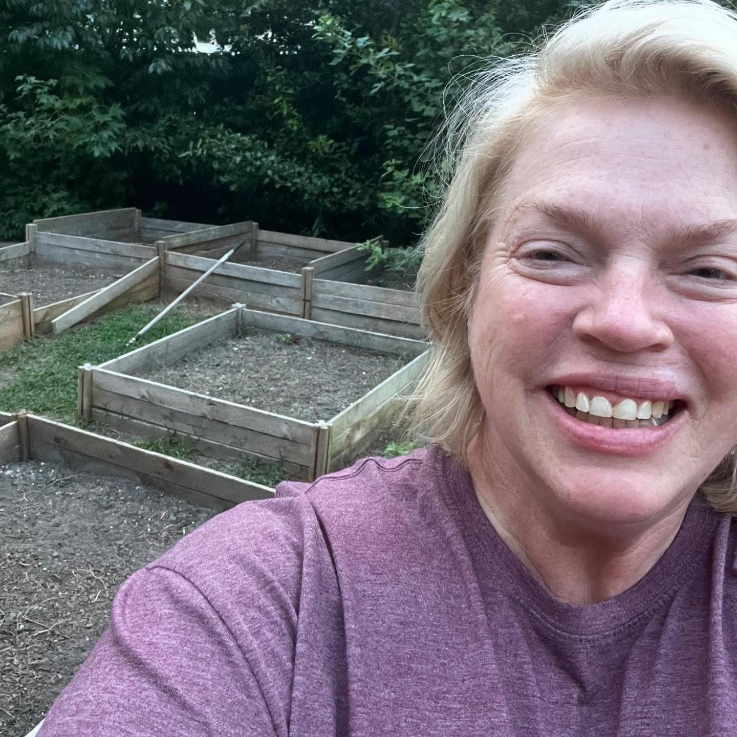 Janelle Brown smiling in her garden