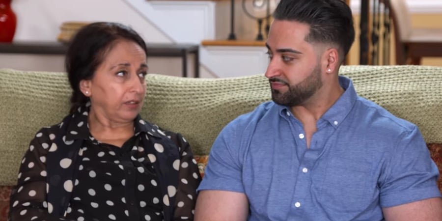 Laila and Shekeb sitting together on a sofa on I Love a Mama's Boy