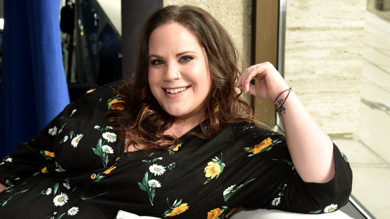 Whitney Thore smiling in a floral dress