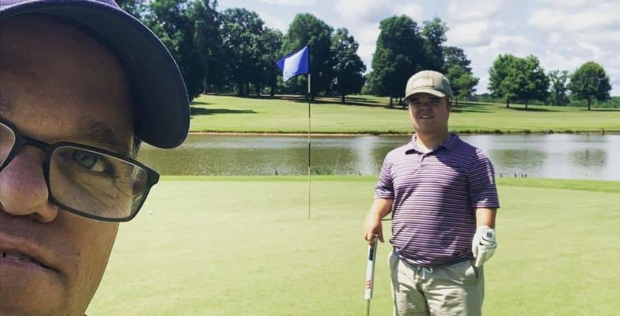 Trent Johnston taking a selfie with Jonah Johnston on a golf course
