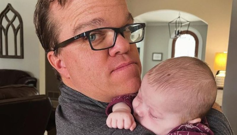 Trent Johnston holding sleeping baby Leighton