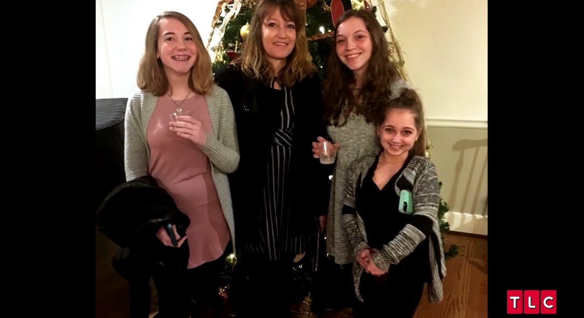Patty Schrankel with daughters Rylee, Tara, and Shauna Rae by a Christmas tree