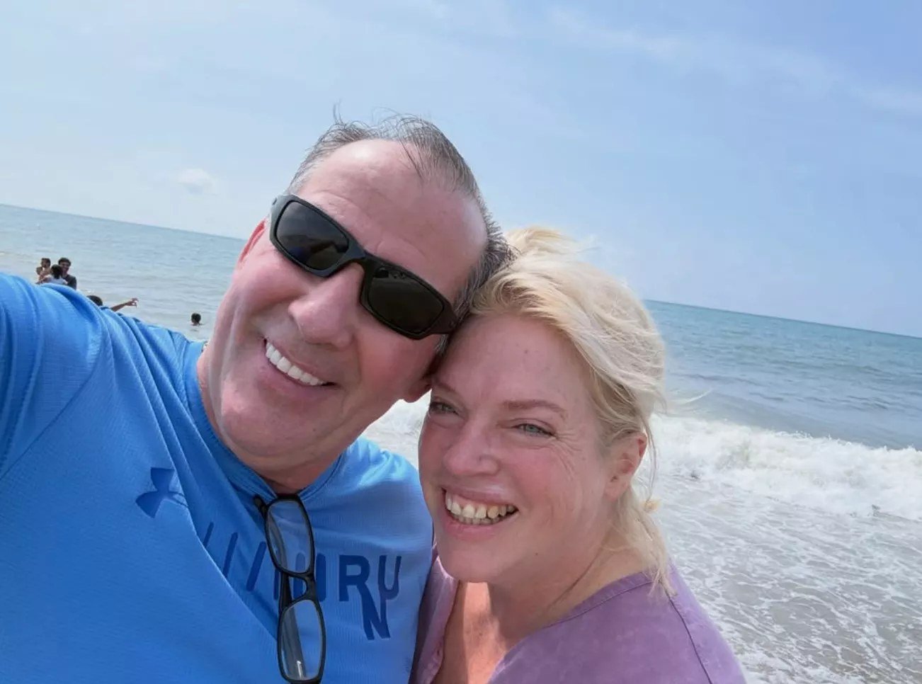 Pete Lathrop and Janelle Brown smiling in a beach selfie