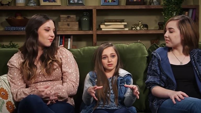 Shauna Rae sitting between sisters Tara and Rylee on a couch