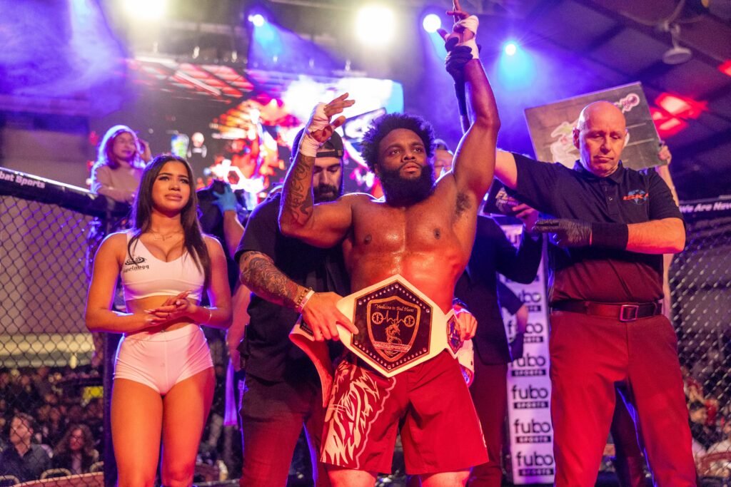Lawrence Bishop holding his MMA title belt