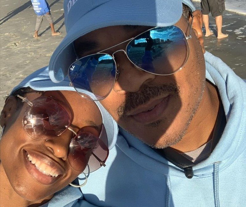 Deon and Karen Derrico smiling in a beach selfie