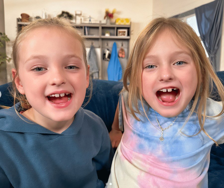 Ava and Olivia Busby smiling close up indoors