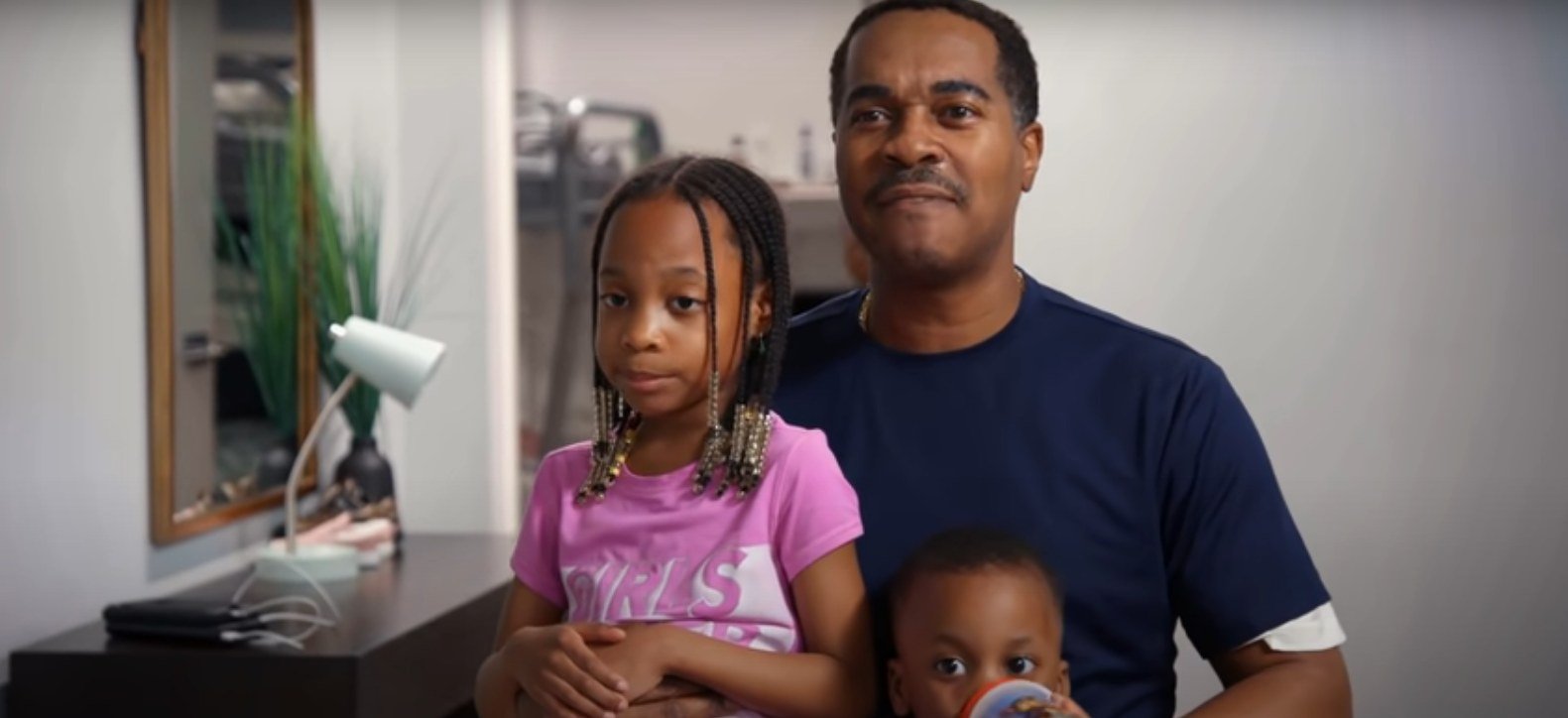 Deon Derrico with two of his children in a confessional-style scene