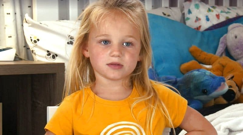Riley Paige Busby in a yellow shirt indoors