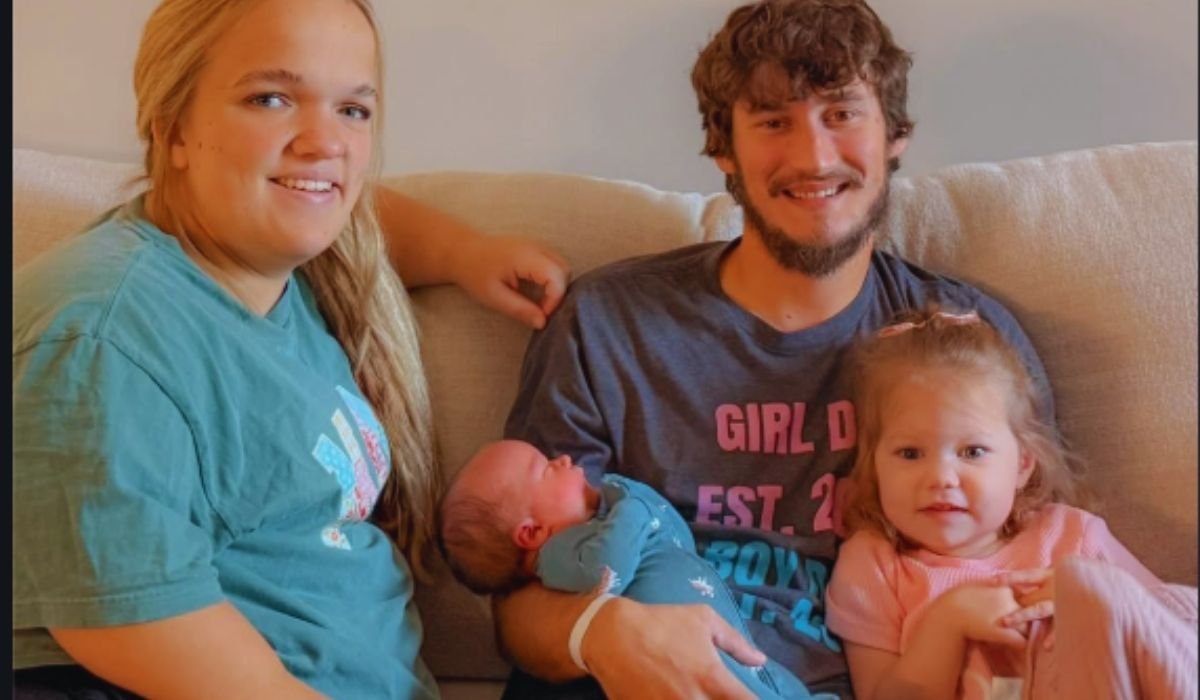Liz Johnston and Brice Bolden with baby Coleman and Leighton on a couch