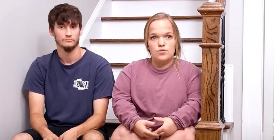 Brice Bolden and Liz Johnston sitting on stairs in a confessional