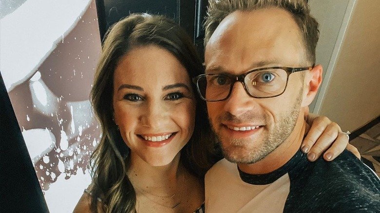 Adam and Danielle Busby taking a smiling date night selfie