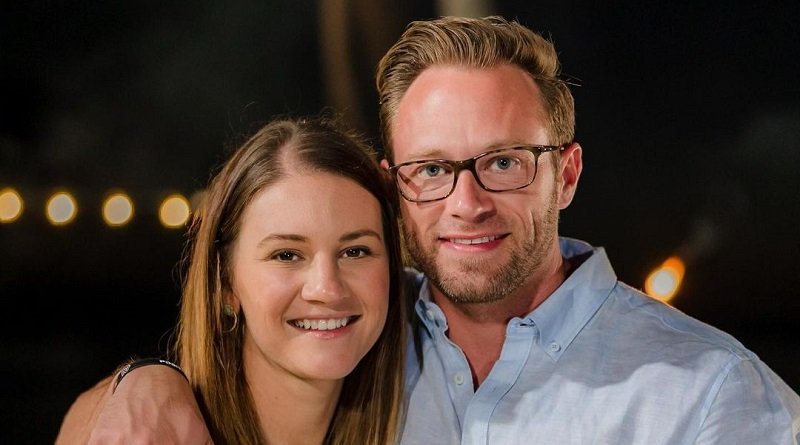 Adam and Danielle Busby smiling together on an evening date night