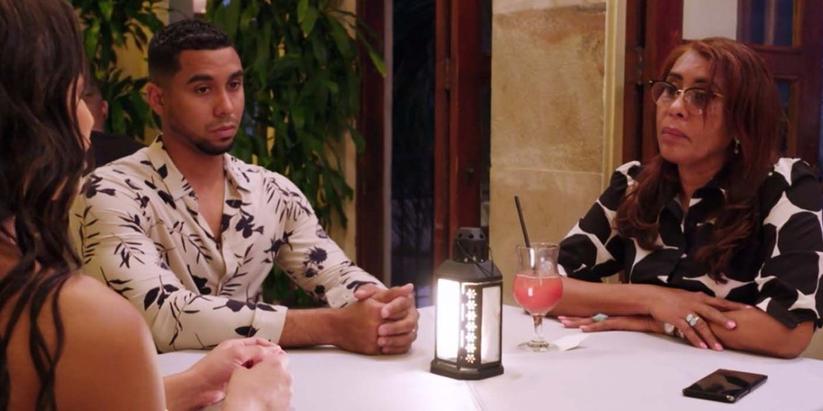 Pedro Jimeno and his mother Lidia Jimeno sitting across from each other at a dinner table