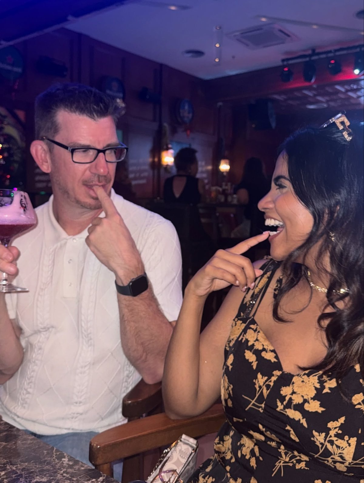 Jonathan Pearce and Ally laughing together at a bar