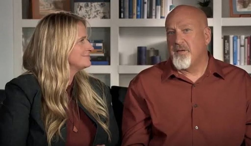 Christine Brown smiling beside her husband David Woolley