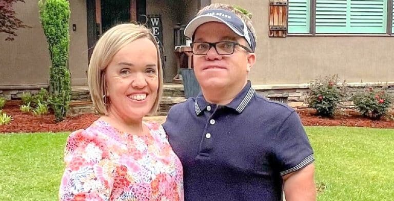 Trent and Amber Johnston smiling together outside their home