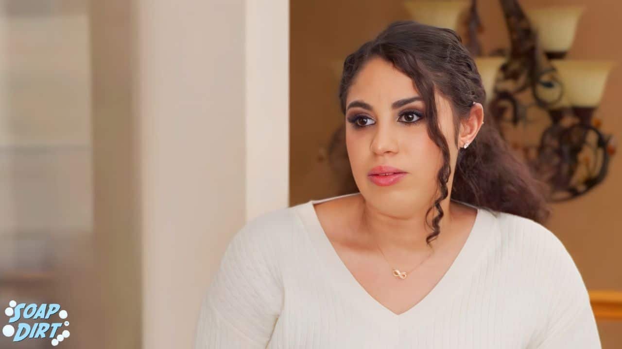 Zuri Soto glancing sideways in a white sweater