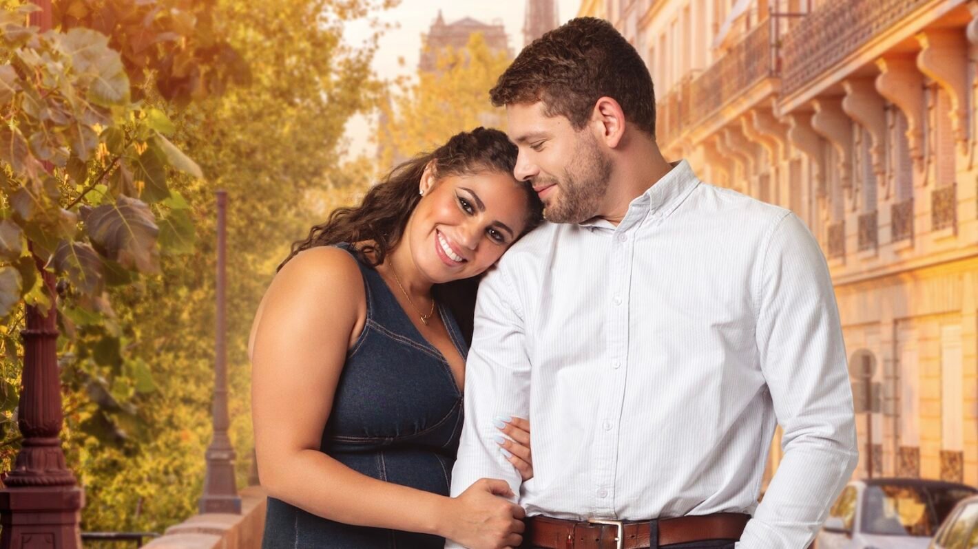 Ben and Zuri smiling together in front of a Paris backdrop