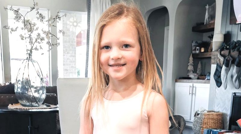 Parker Kate Busby smiling indoors with long hair
