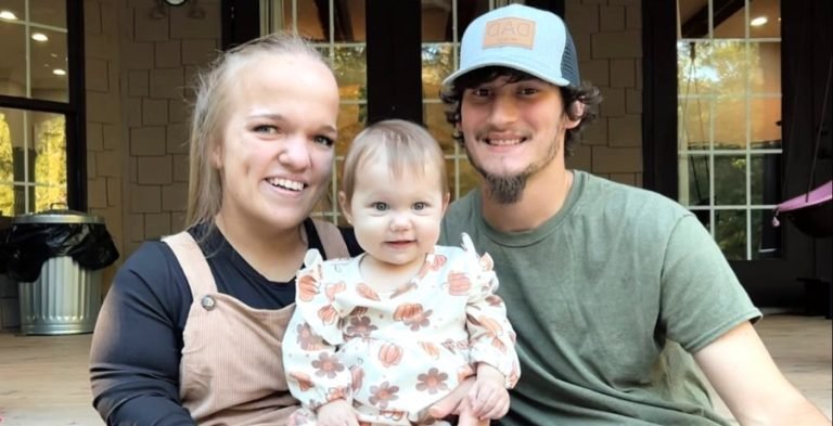 Liz Johnston, Brice Bolden and baby Leighton smiling together outdoors