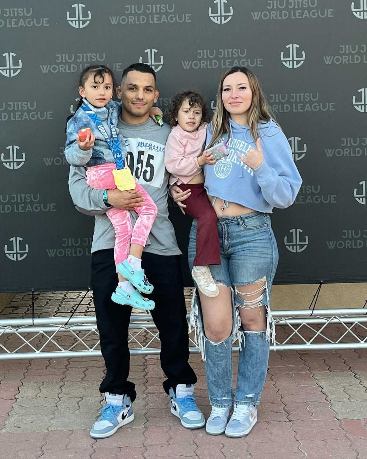 Roberto and Kristy with their two daughters at a Jiu Jitsu World League event