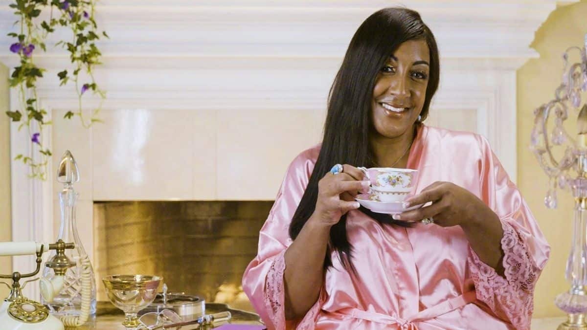 Karen Everett smiling while holding a teacup