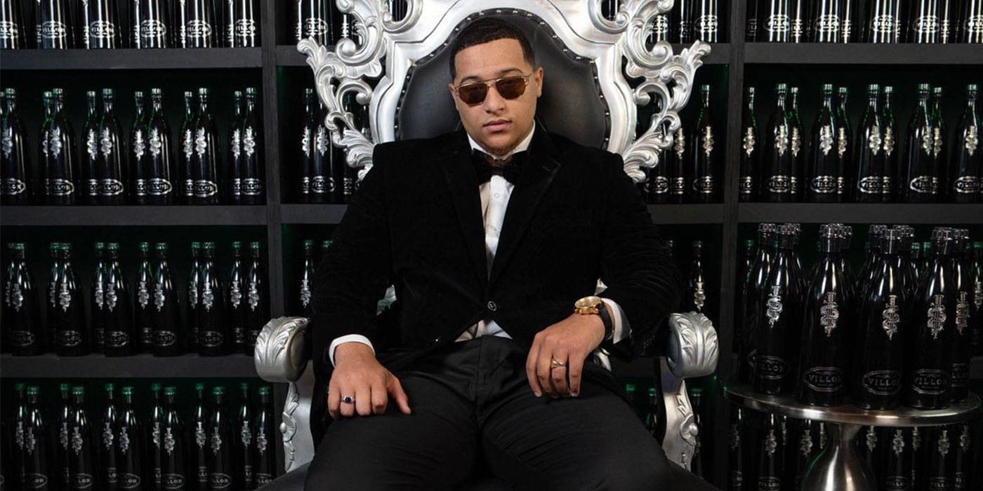 River Everett in a suit sitting on an ornate throne chair