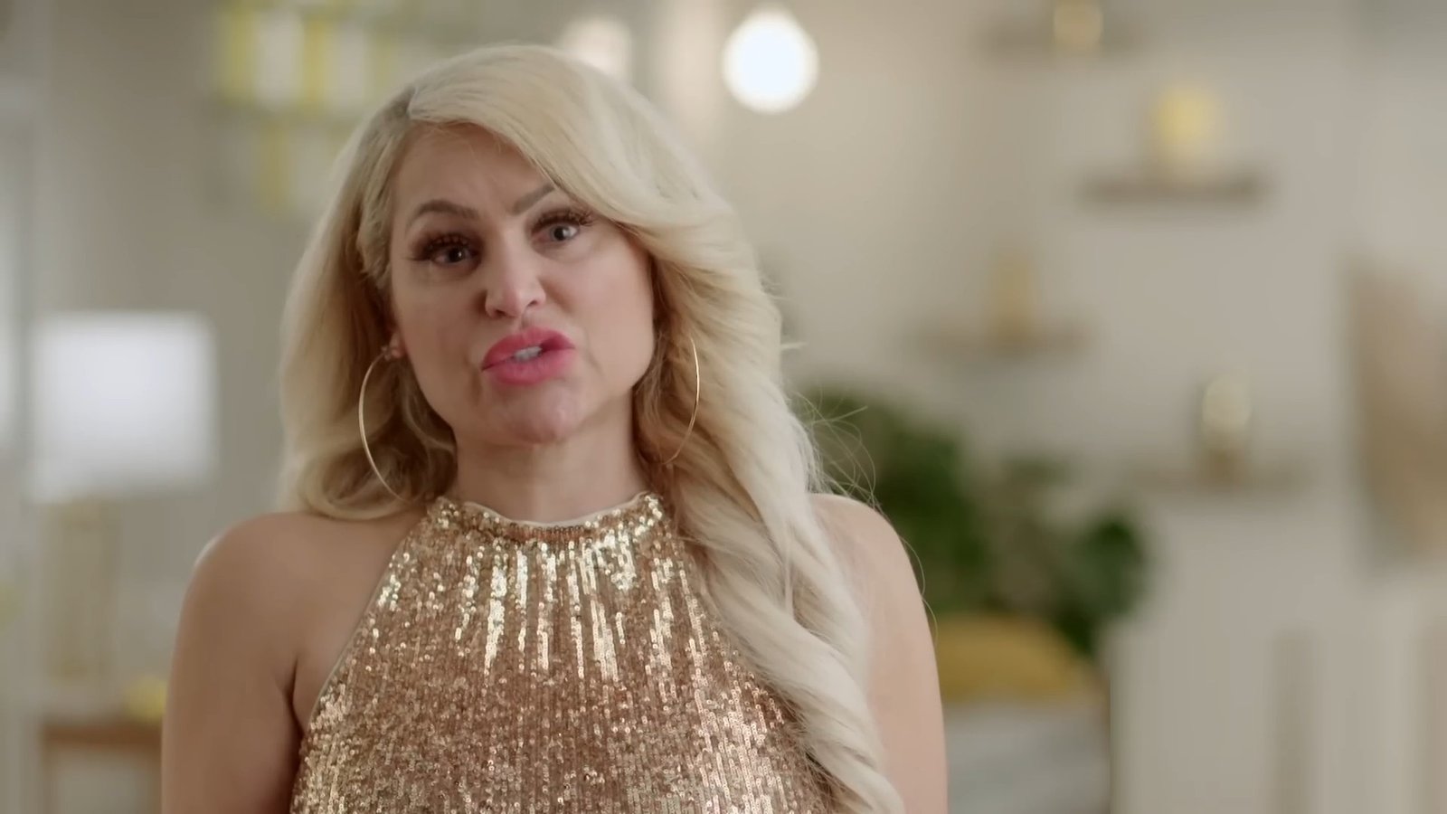Darcey Silva in a gold sequin top in a confessional