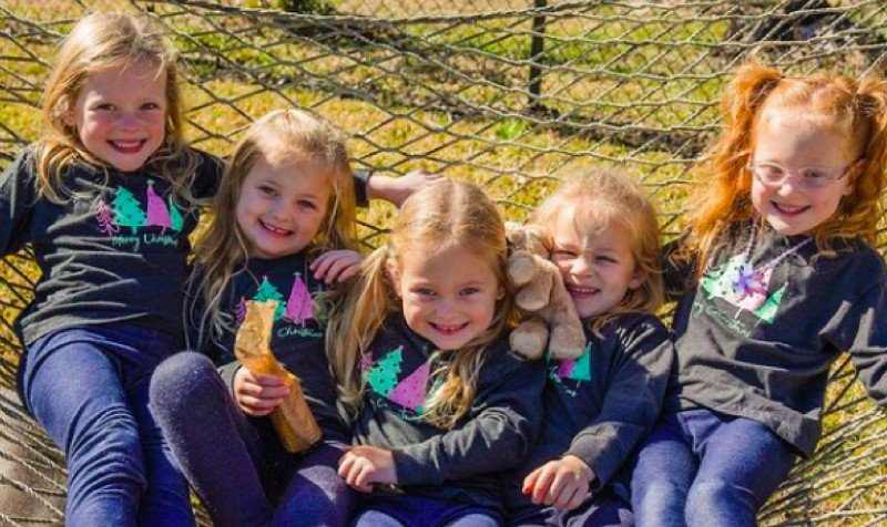 The five Busby quints together in a hammock outdoors