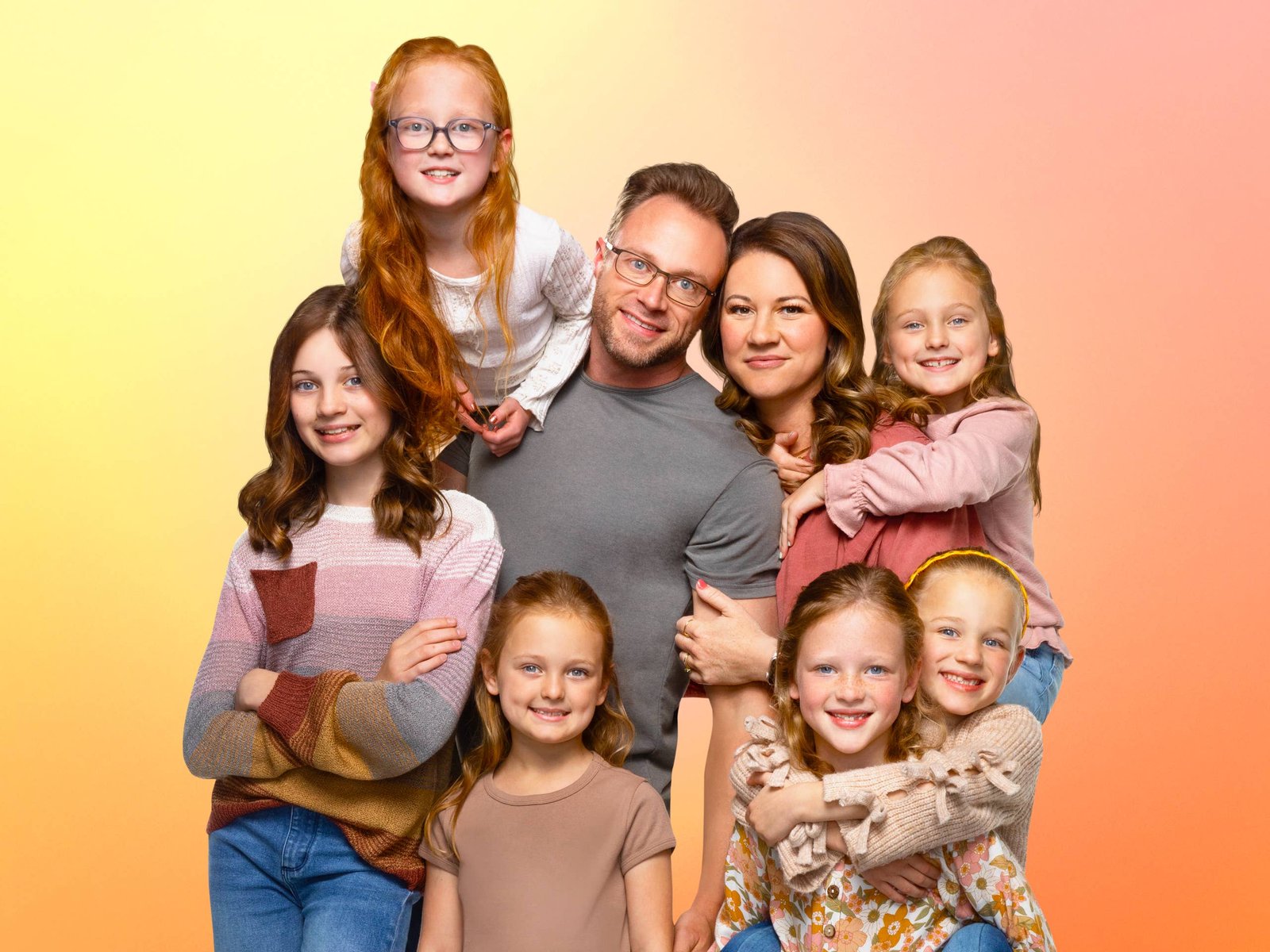 Adam and Danielle Busby with Blayke and the five quints in a studio portrait