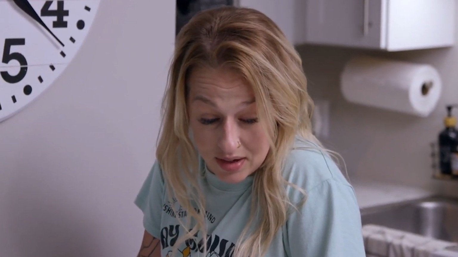 Amanda Conner looking down in a kitchen