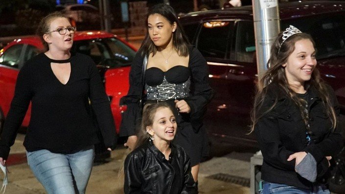 Shauna Rae out at night with friends, laughing in a leather jacket