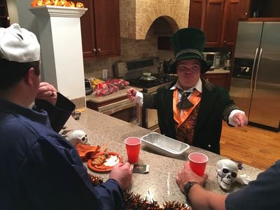 Trent Johnston in his Wizard costume at a Halloween party table