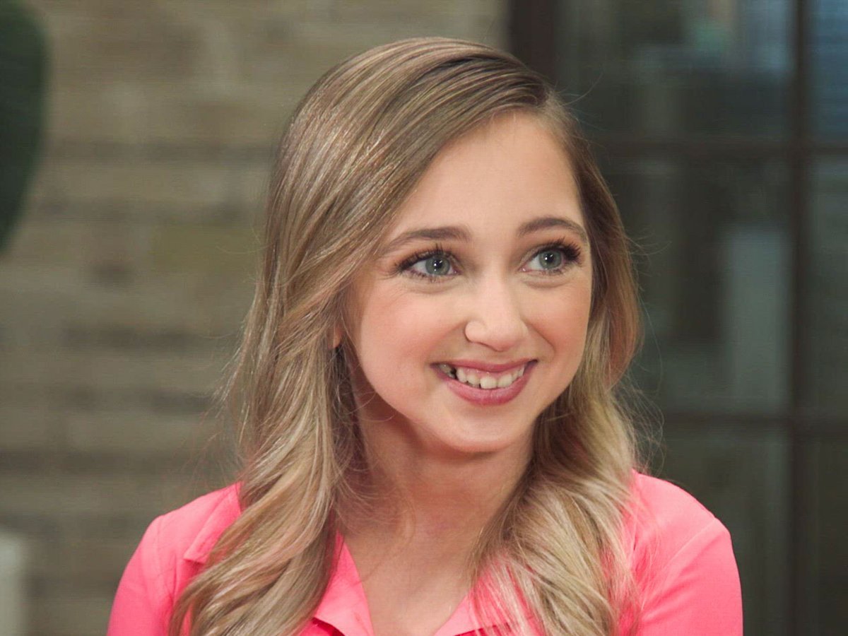 Shauna Rae smiling in a bright pink top