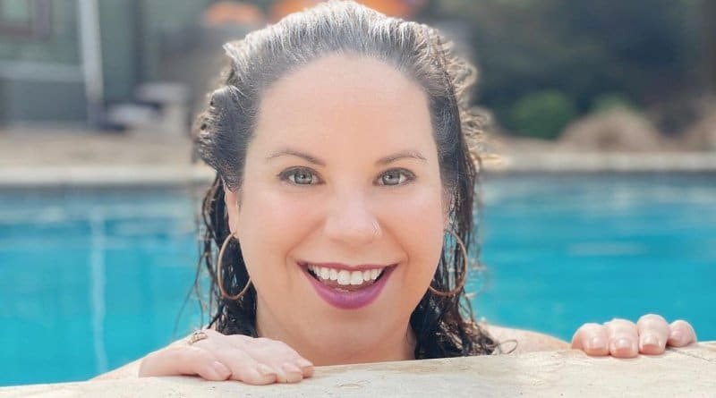 Whitney Way Thore smiling by a pool