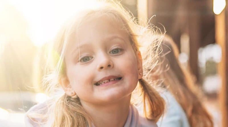 Ava Busby smiling in golden sunlight