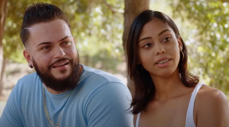 Nicole Jimeno and Alejandro Padron sitting together outdoors