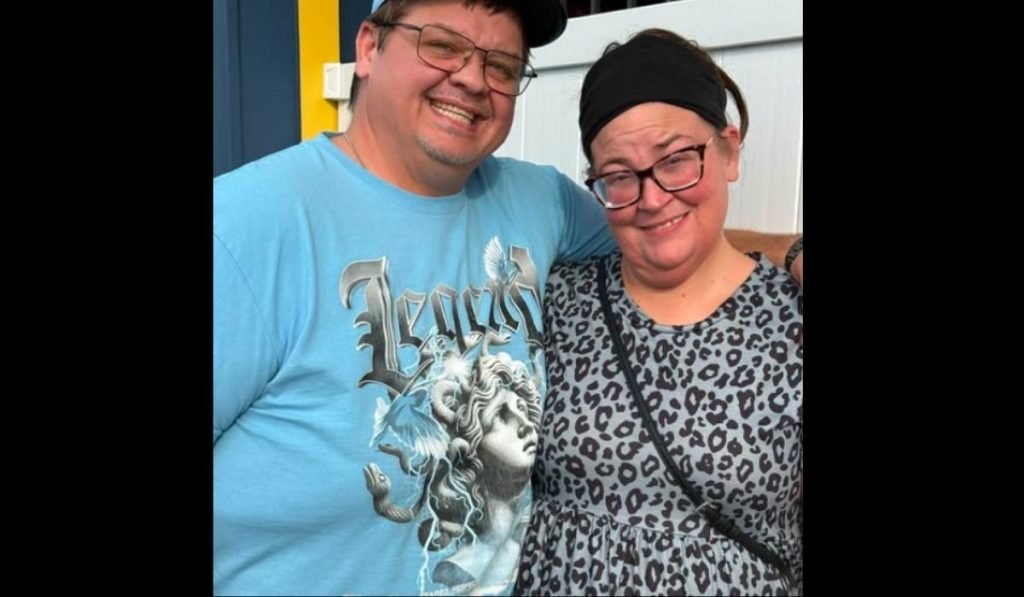 Chris Combs and Brittany Combs smiling together outdoors, Brittany in a leopard-print top and black headband