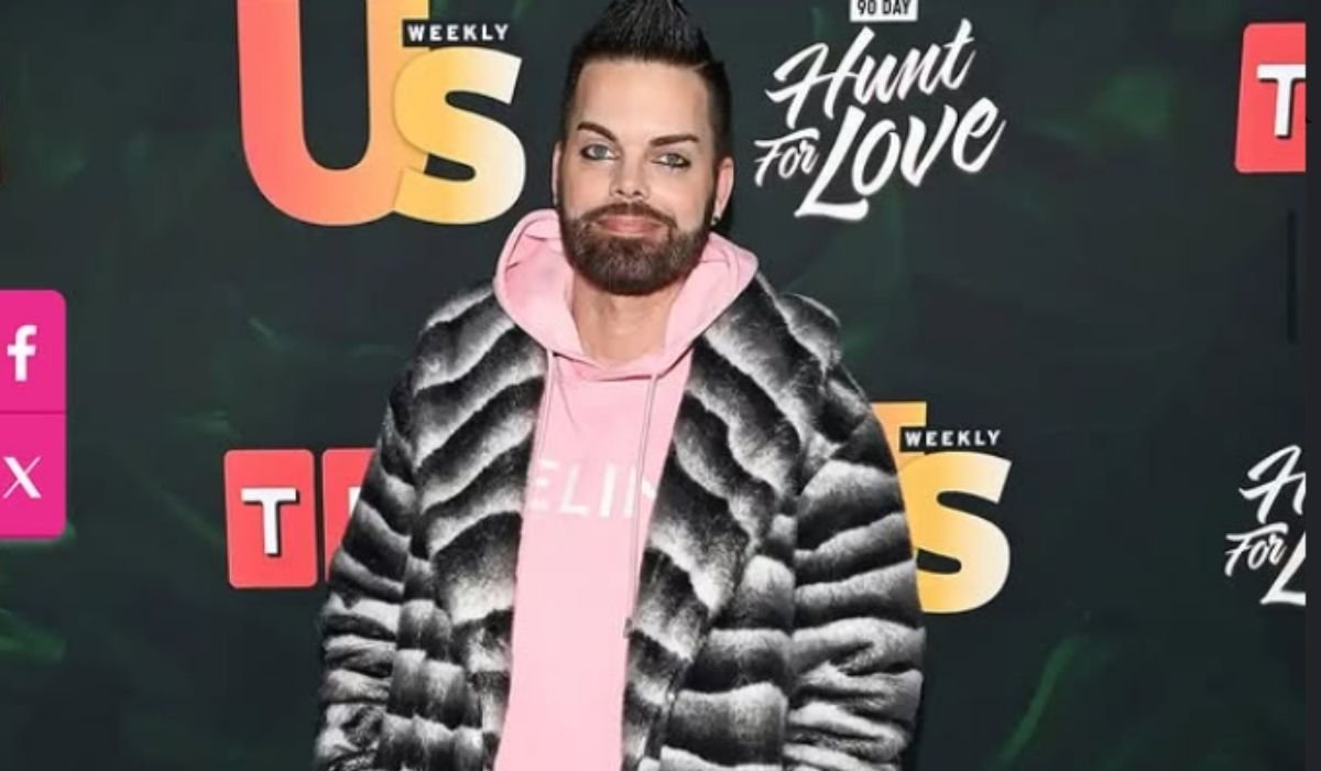 Tim Malcolm in a fur coat and pink hoodie at a Hunt for Love event