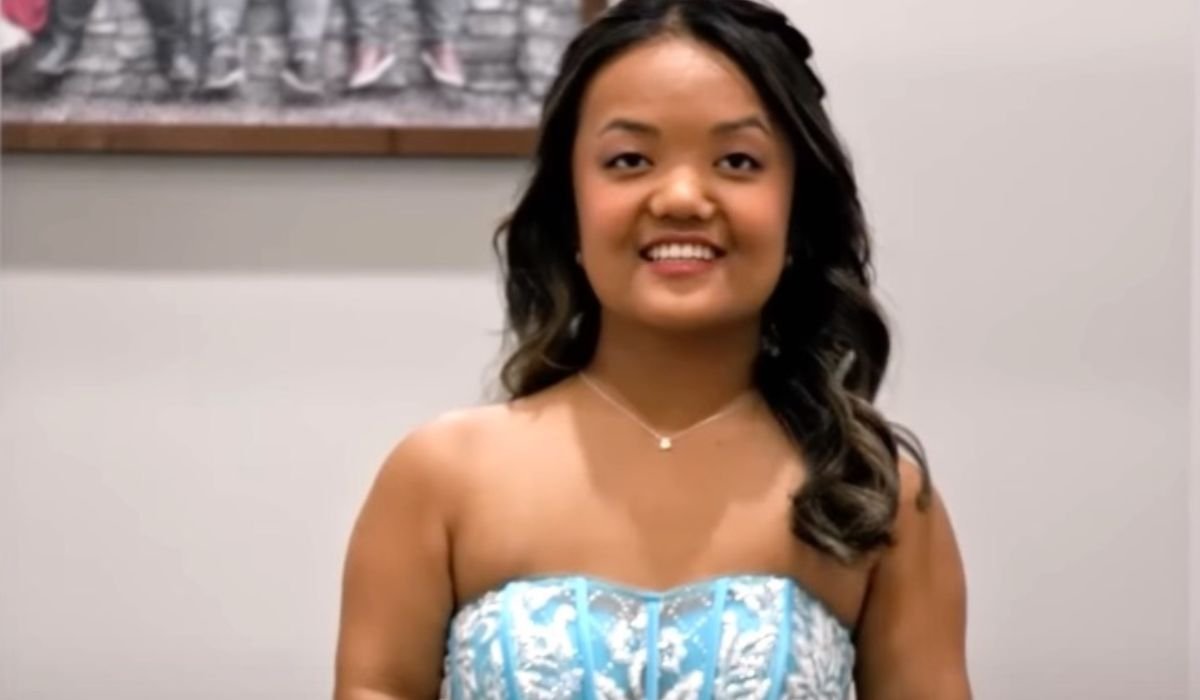 Emma Johnston smiling in a blue gown