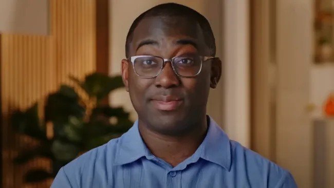 Niles speaking to camera in a blue shirt