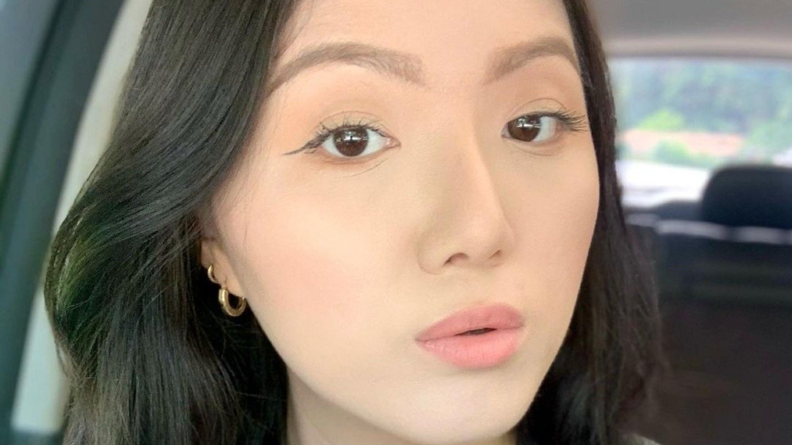 Emily Chu in a close-up selfie in a car