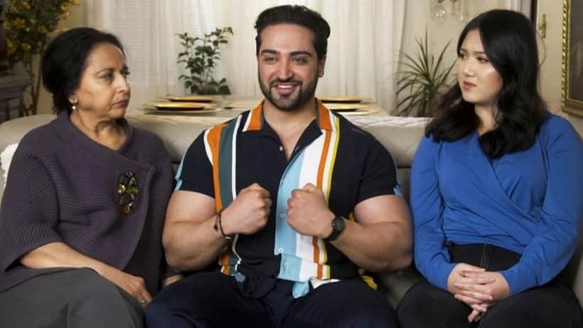 Laila, Shekeb and Emily sitting on a couch during a tense scene