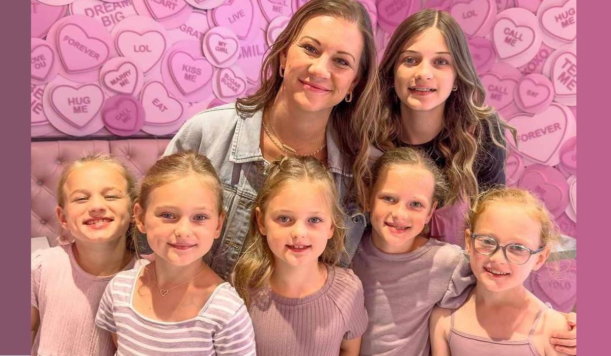 Danielle Busby with her six girls against a candy-heart wall