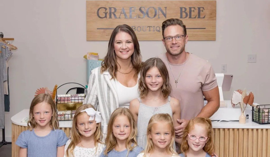 Adam and Danielle Busby with the quints at Graeson Bee boutique