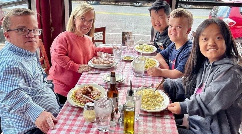 The Johnston family sharing a meal together at a restaurant table
